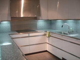 Modern kitchen with stainless steel appliances and granite countertops