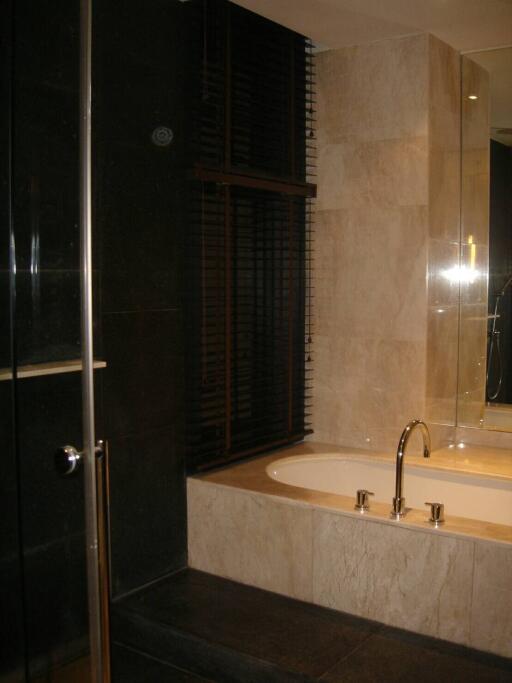 Modern bathroom with a tub and glass shower