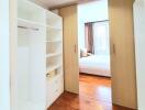 Spacious bedroom with walk-in closet and wooden flooring