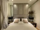Elegant modern bedroom with double bed, bedside tables, and decorative mirrors