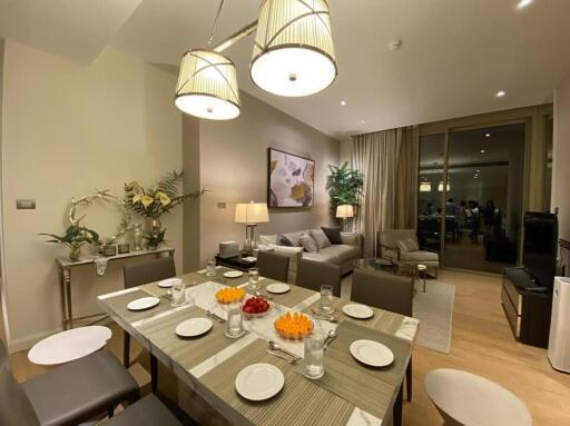 Modern living and dining area with a set dining table and cozy seating