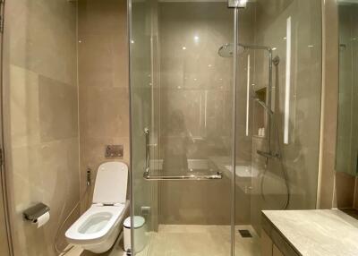 Modern bathroom with glass shower enclosure and toilet