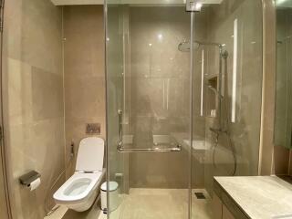 Modern bathroom with glass shower enclosure and toilet