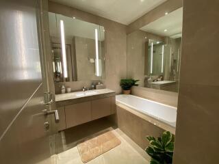 Modern bathroom with double vanity and bathtub