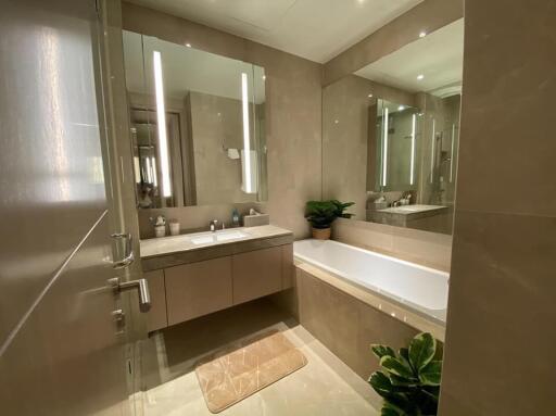 Modern bathroom with double vanity and bathtub