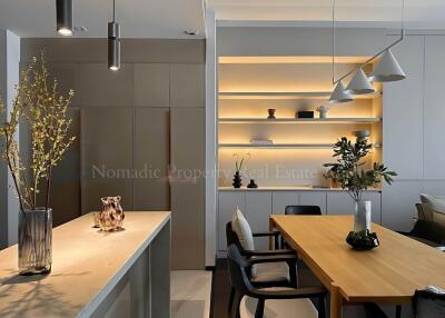 Modern dining area with wooden table and decorative shelves