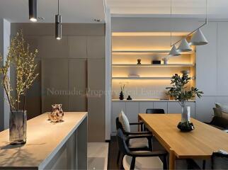 Modern dining area with wooden table and decorative shelves