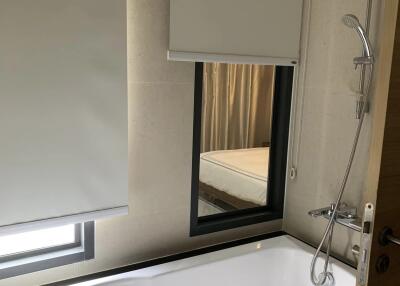 Modern bathroom with bathtub and window treatments
