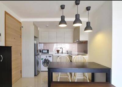 Modern kitchen and dining area with lighting fixtures