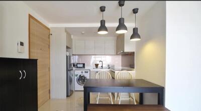 Modern kitchen and dining area with lighting fixtures