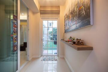 Modern hallway with glass doors and floating shelf