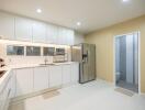 Modern kitchen with stainless steel appliances and white cabinetry