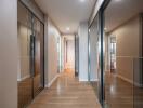 Modern hallway with wooden flooring and mirrored closets