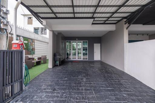 Spacious covered garage with a grill and outdoor seating