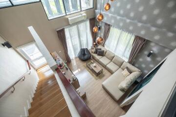 Spacious living room with high ceiling and modern decor