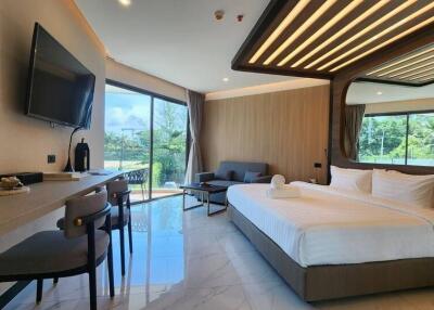 Spacious bedroom with large windows, comfortable bed, and modern furnishings