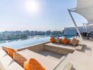 Outdoor lounge area with pool and lake view