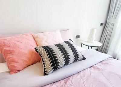 Cozy bedroom with pastel-colored bedding