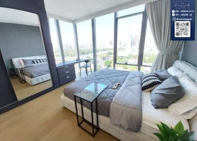 Modern bedroom with large windows and city view