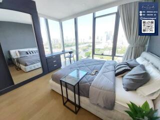 Modern bedroom with large windows and city view