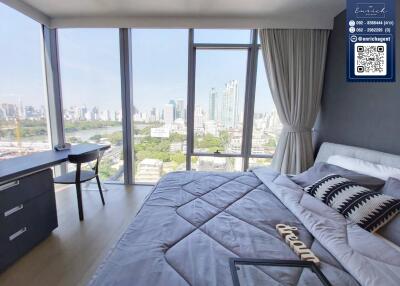 High-rise bedroom with large windows and city view