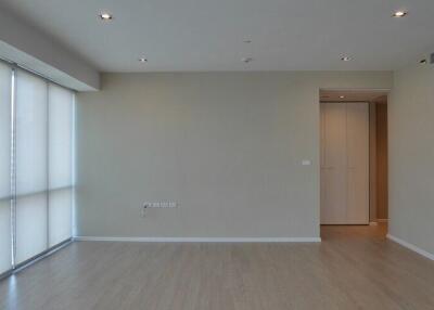 Empty modern living room with hardwood floor and large windows