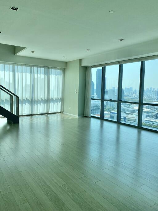 Spacious modern living room with large windows and city view