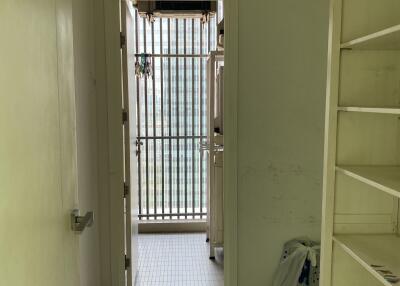 Utility room with a doorway leading to a balcony