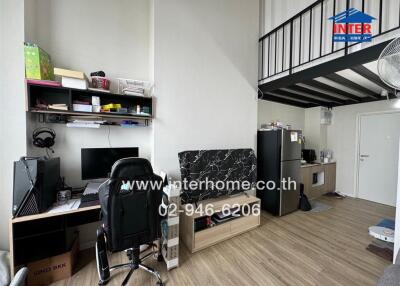 Living space with loft, computer desk, and kitchenette