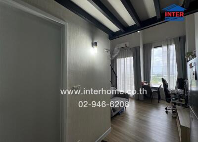 Main living area with natural light and wooden flooring