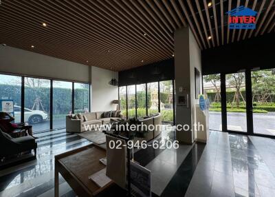 Elegant hotel lobby with seating area and large windows
