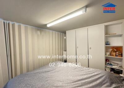 Bedroom interior with wardrobe, bed, and shelves