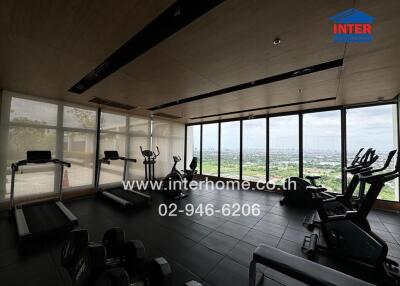 Spacious gym with large windows and city view