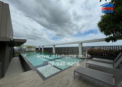 Outdoor pool area with a deck and seating