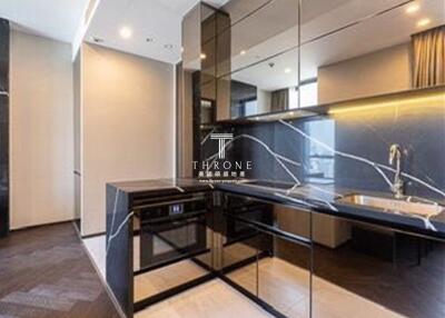 Modern kitchen with sleek black cabinetry and integrated appliances