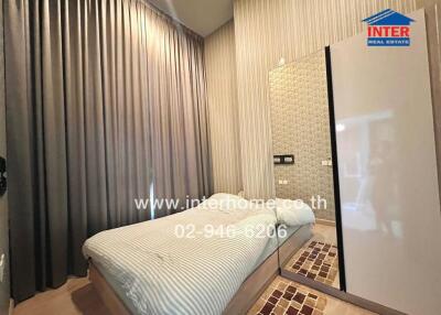 Bedroom with bed, large mirror, modern decor, and tall curtains