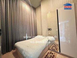 Bedroom with bed, large mirror, modern decor, and tall curtains