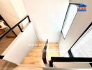 Staircase with wooden steps and modern railing