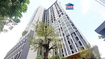 Facade of a high-rise residential building with greenery