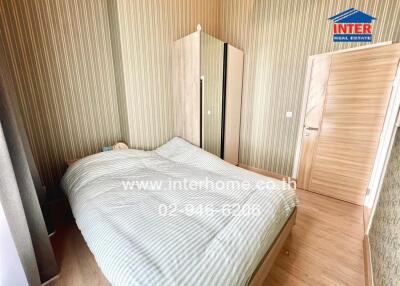 Bedroom with bed, wardrobe, and wooden flooring