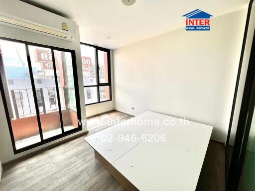 Bedroom with large windows and wooden floor