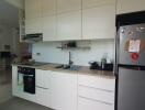 Modern kitchen with integrated appliances and overhead storage