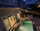 Outdoor area with a swimming pool and string lights