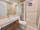 Modern bathroom with a glass shower, a vanity with sink, and tiled walls