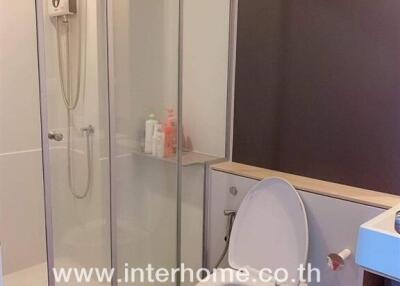 Modern bathroom with shower, toilet, and vanity unit