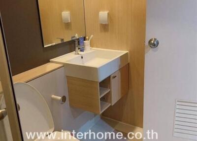 Modern bathroom with sink, toilet, and mirror