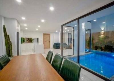 Modern dining area with a view of an indoor pool