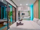 Modernly decorated bedroom with a large bed and sliding glass doors to the balcony