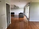 Spacious living room with wooden flooring and large window