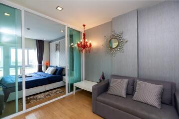 Modern bedroom with a sofa and chandelier